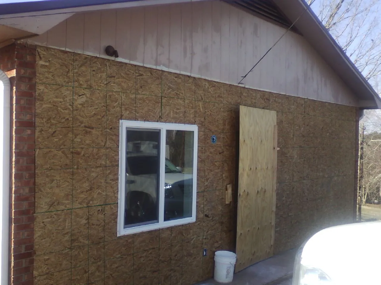OSB sheathing on a garage addition wall before siding in Jerusalem