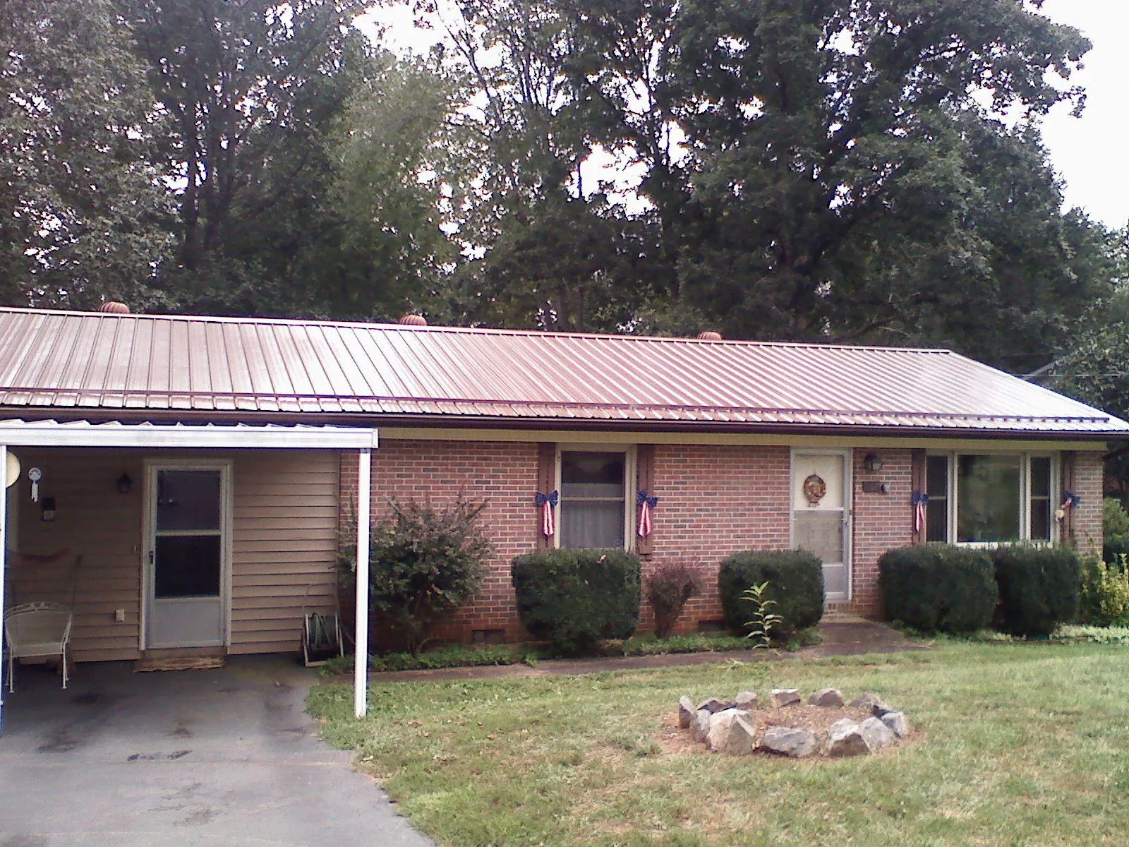 Bronze metal roof and carport on a brick ranch home — Roof Repair work by our crew in Jerusalem