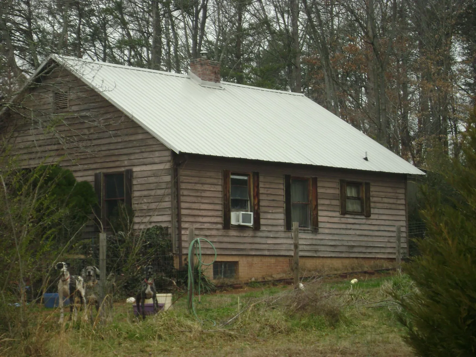 White metal roof on an old wood sided farmhouse, from a Asphalt Shingle Roof Repair job in Jerusalem
